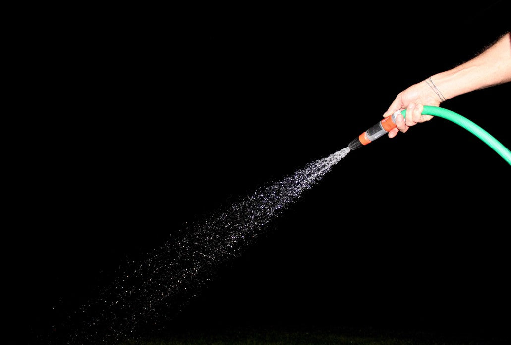 Person holding a hose