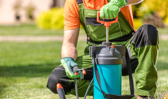 Man applying lawn chemicals in tank sprayer