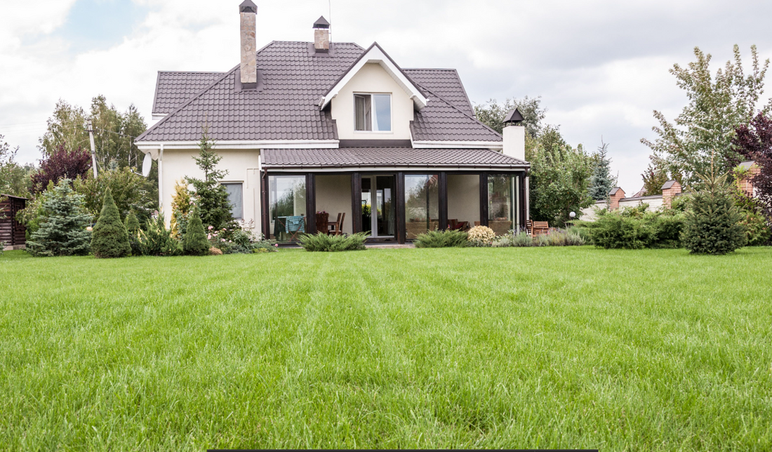 A beautiful two story home with a large green lawn