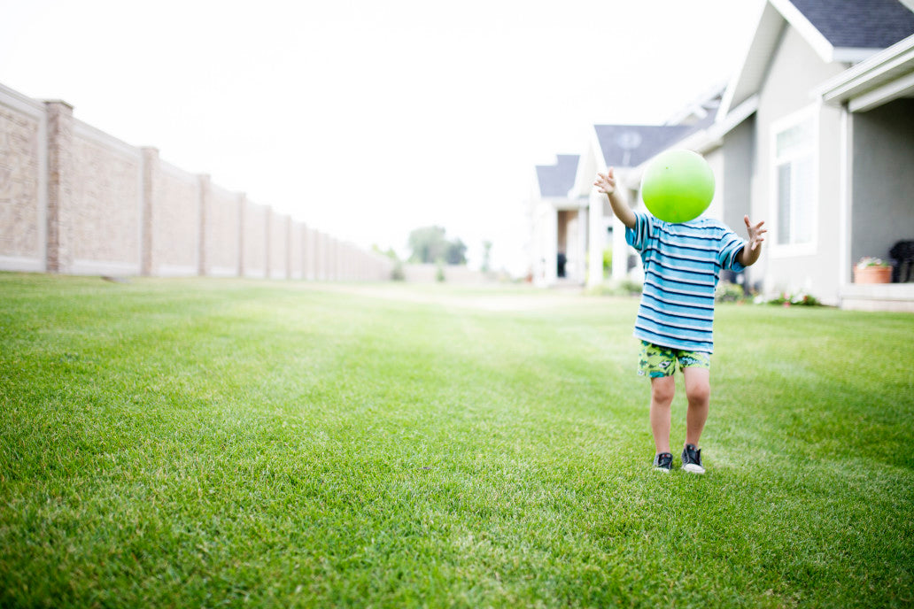 little boy running on grass