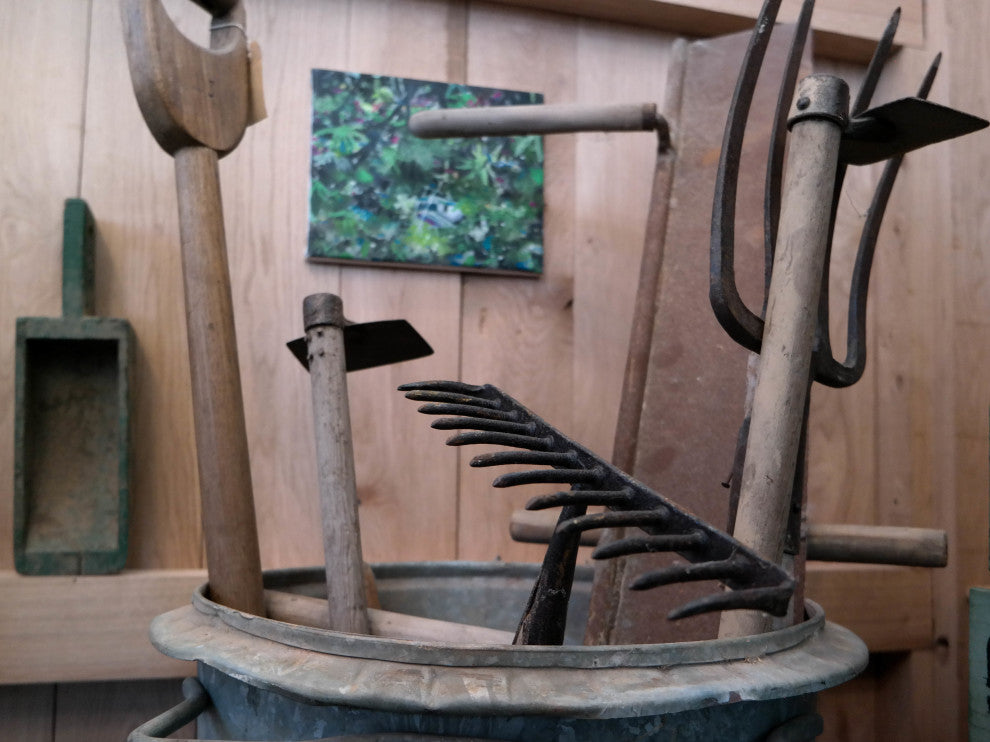 a rake and other gardening tools