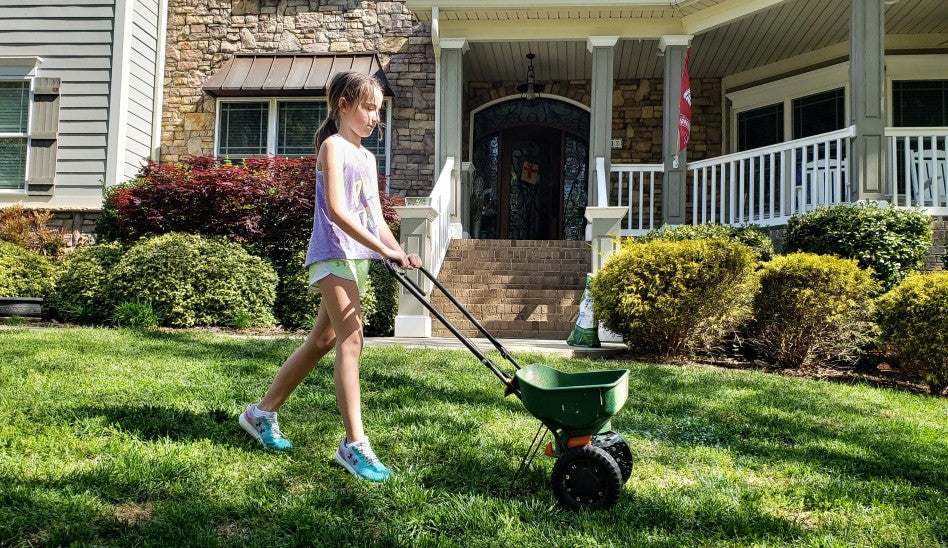 Little girl doing lawn work.