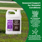 A white plastic jug of Simple Grow Solutions Seaweed Support for Stressful Conditions is shown standing in a grassy outdoor area. The product label features purple and brown sections with product details.