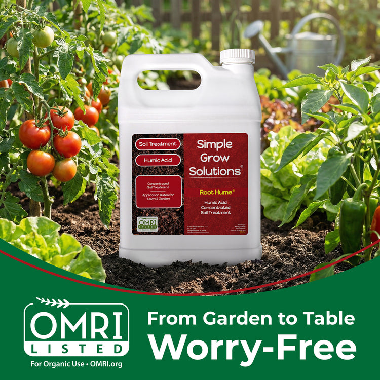 A white plastic jug of OMRI Listed Simple Grow Solutions Root Hume Nutrient Acid soil treatment stands in garden soil surrounded by tomato plants and green foliage, with a green banner at the bottom reading &