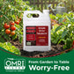 A white plastic jug of OMRI Listed Simple Grow Solutions Root Hume Nutrient Acid soil treatment stands in garden soil surrounded by tomato plants and green foliage, with a green banner at the bottom reading &