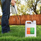 Man applying high potassium lawn fertilizer to back yard with pump-sprayer